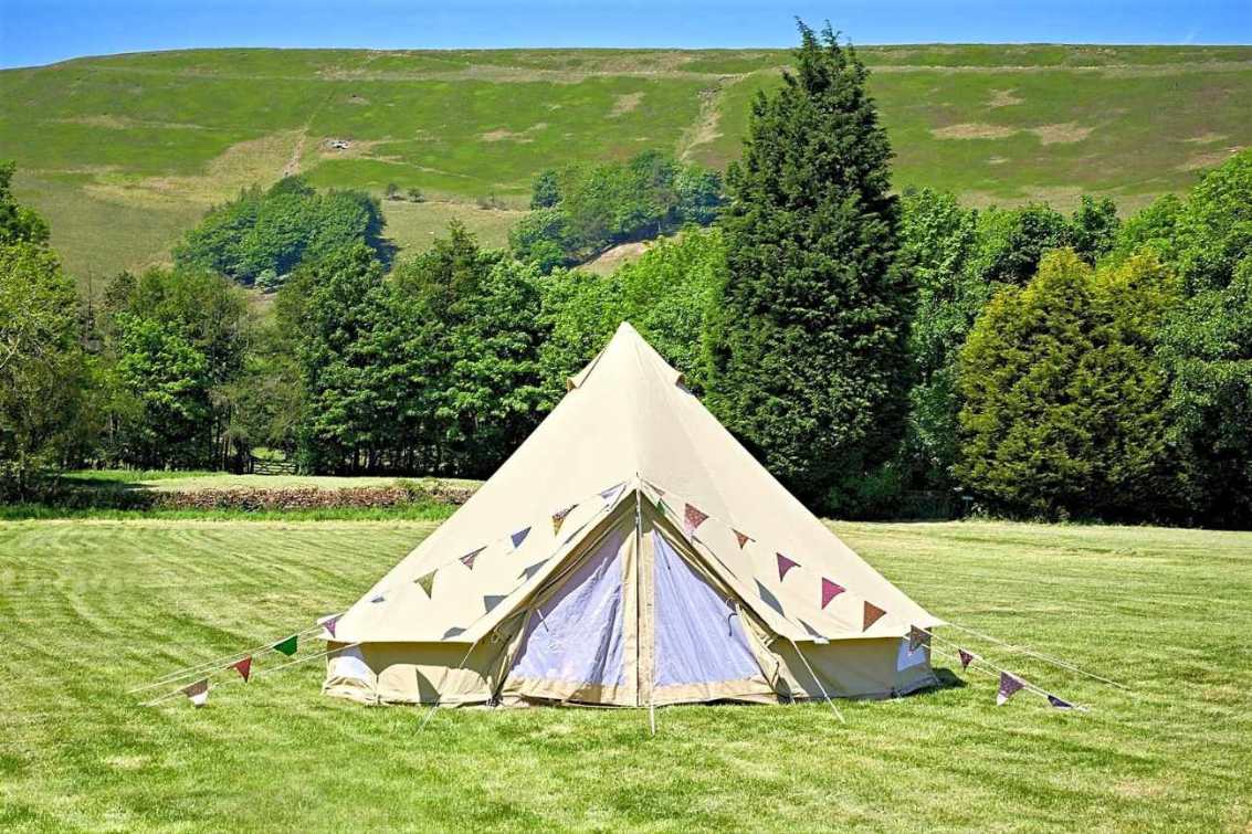 newfold-farm-bell-tent-in-field-with-hills-in-background