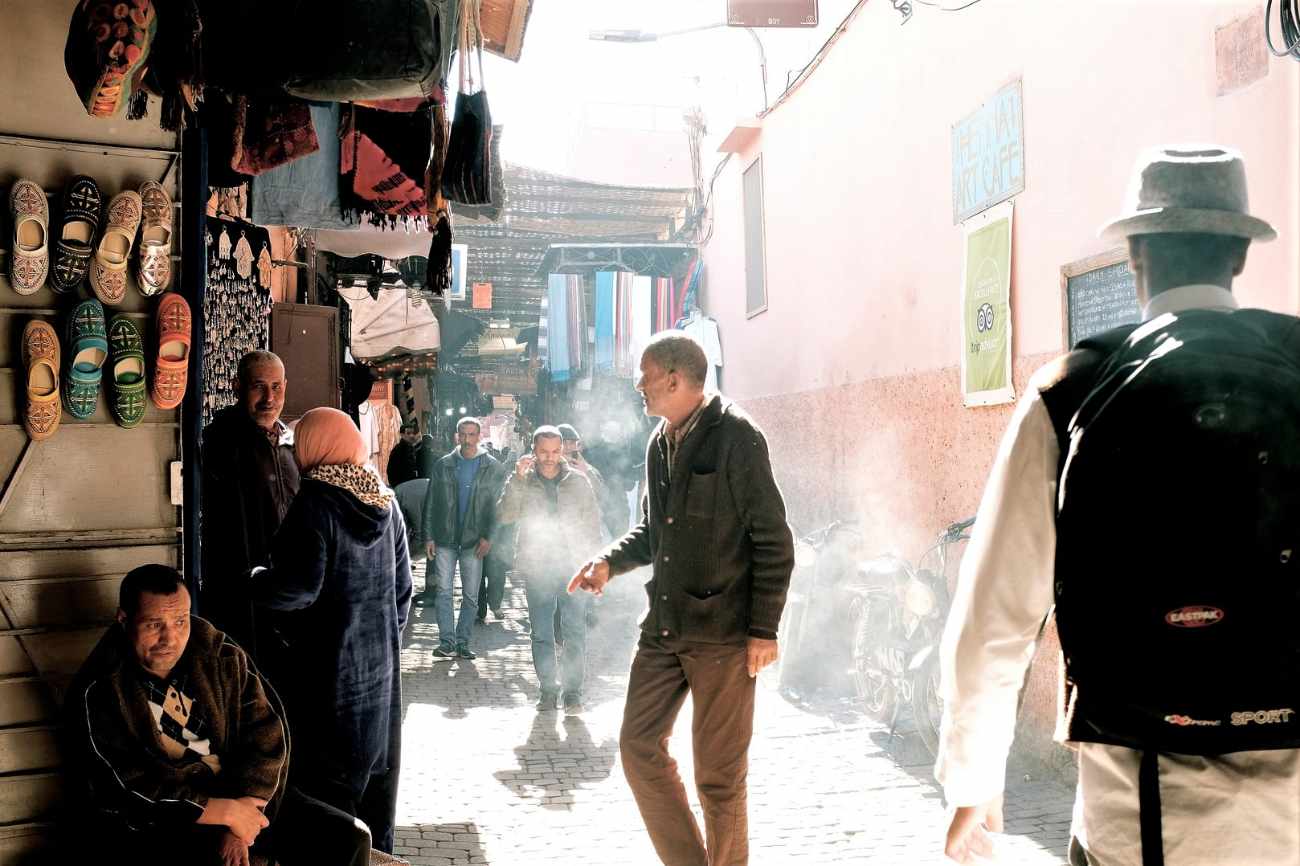 people-walking-down-smokey-alleyway-in-marketplace