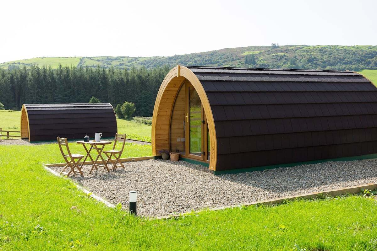 two-kilbane-glamping-pods-in-field-by-forest