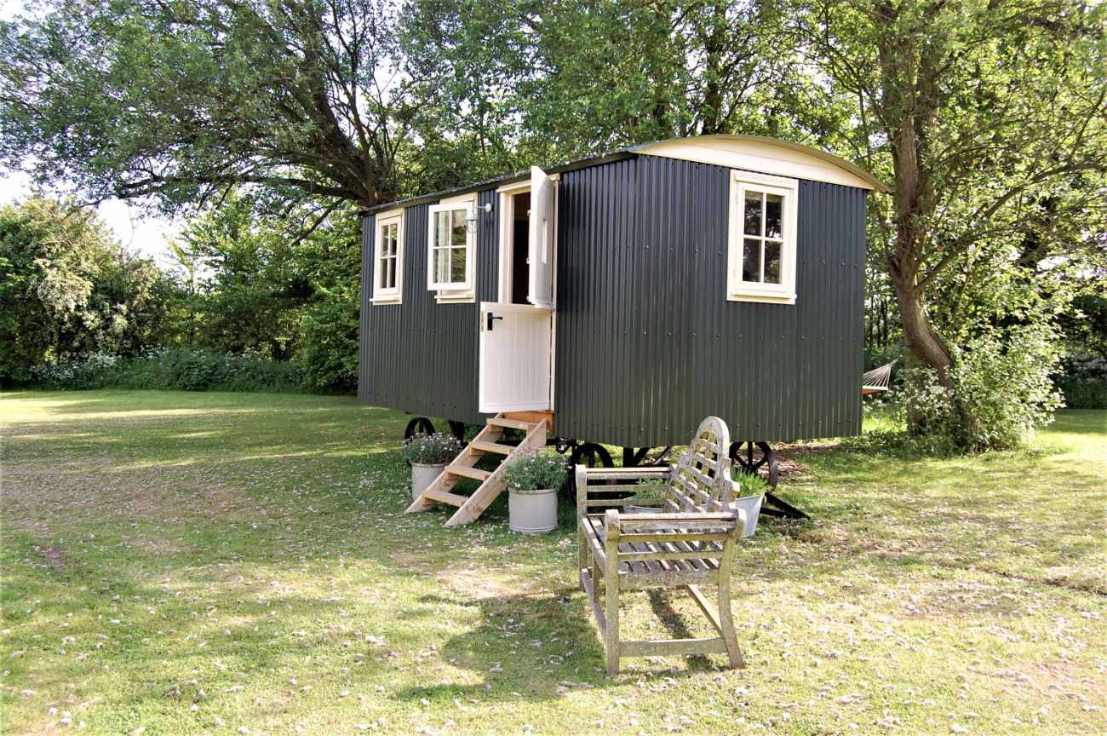 huntingfield-hut-shepherds-hut-in-field-with-bench-glamping-kent