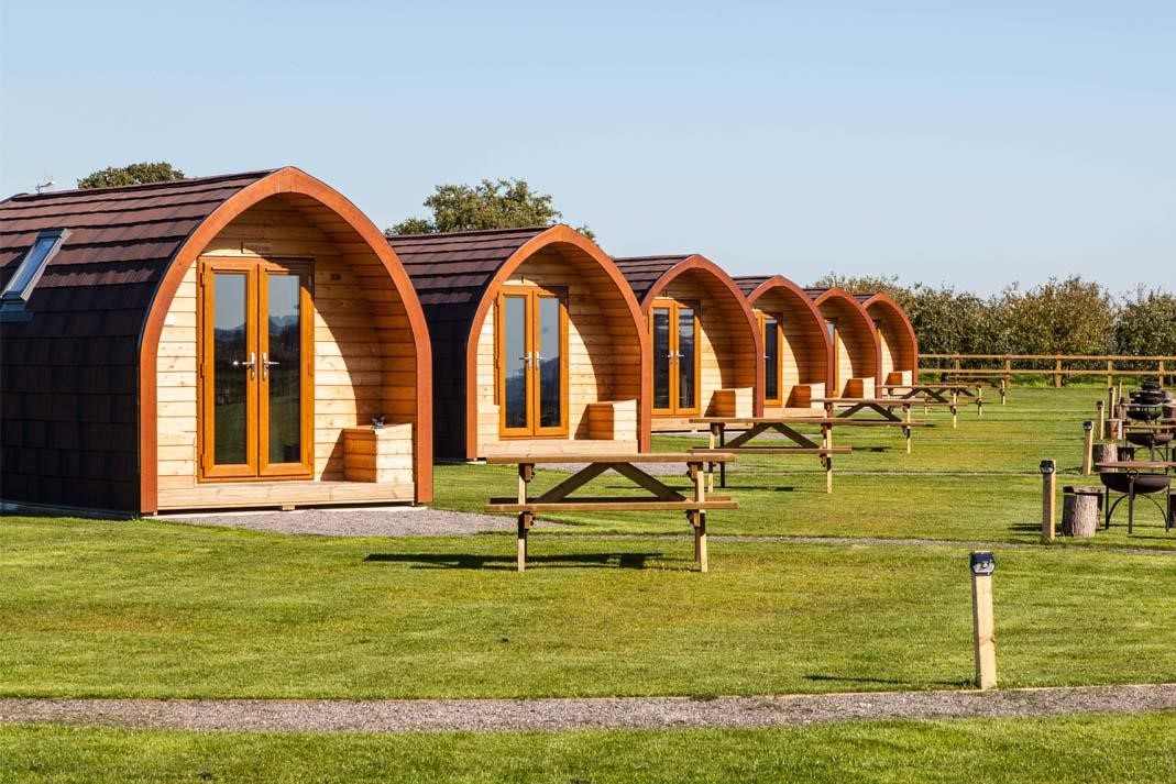 row-of-rankins-farm-glamping-pods-in-field