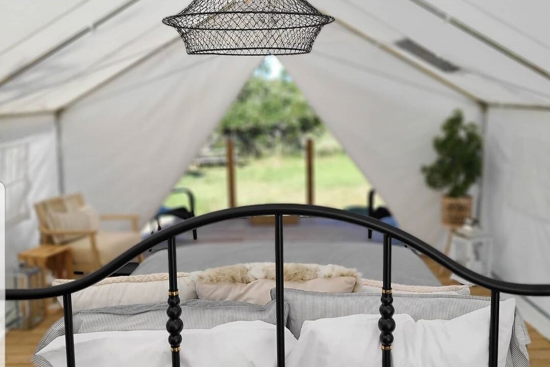 bed-and-living-area-inside-the-grove-tent-at-butterfly-creek