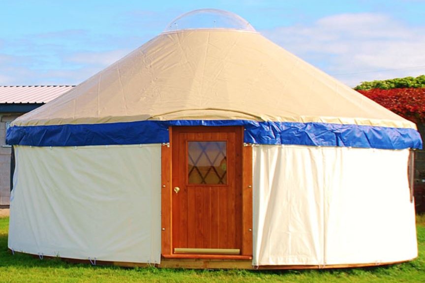 cosy-white-yurt-in-field-on-sunny-day