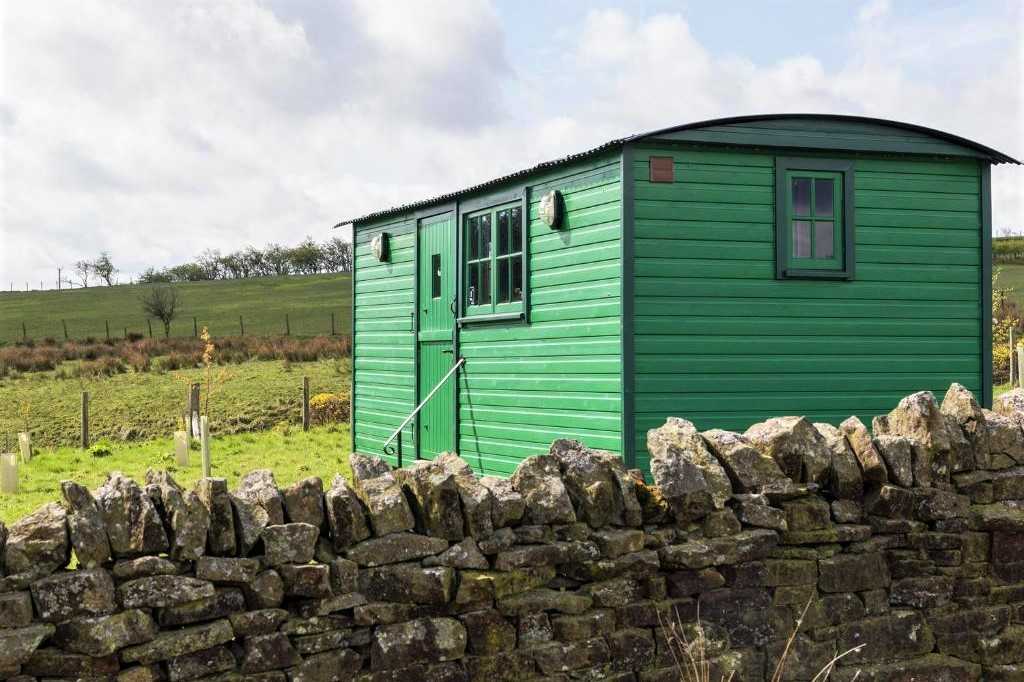exterior-of-green-peat-gate-shepherds-hut-in-field