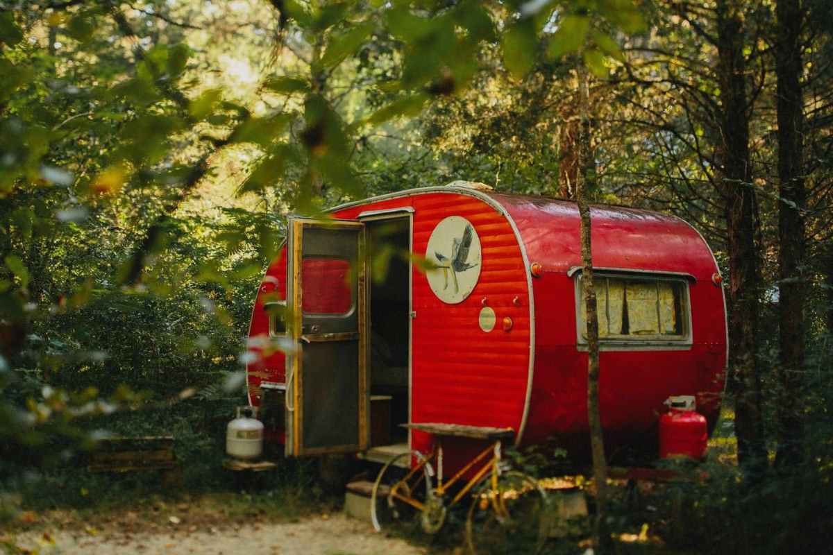 exterior-of-red-camp-grits-campervan-in-woodland