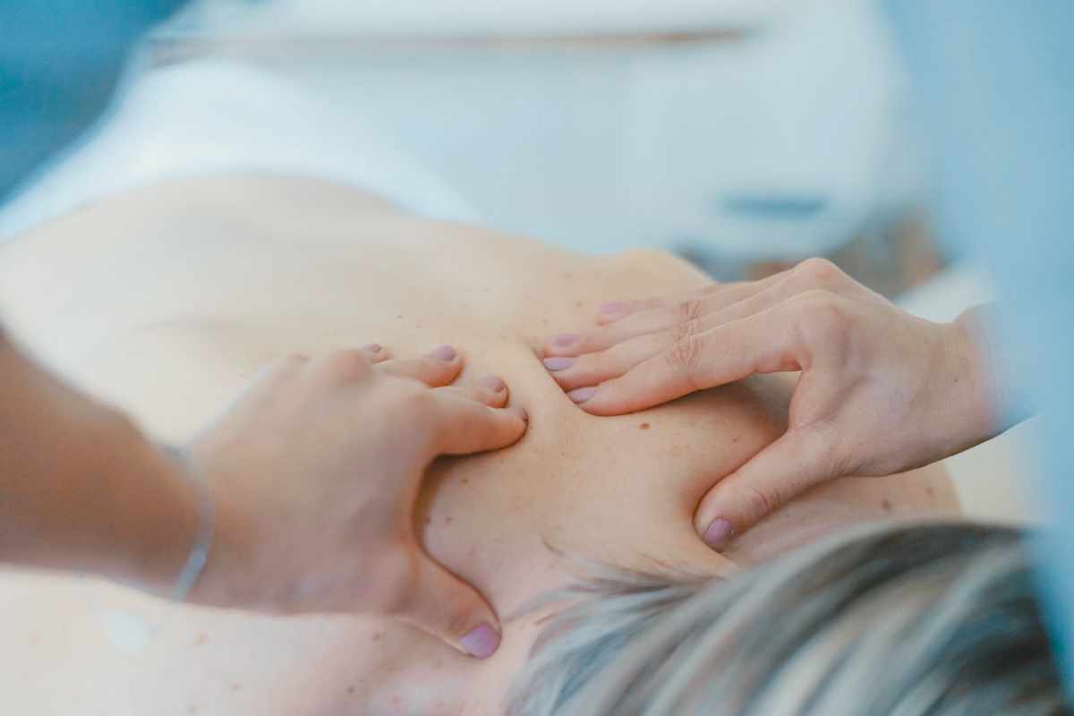 hands-massaging-back-at-just-human-mobile-spa