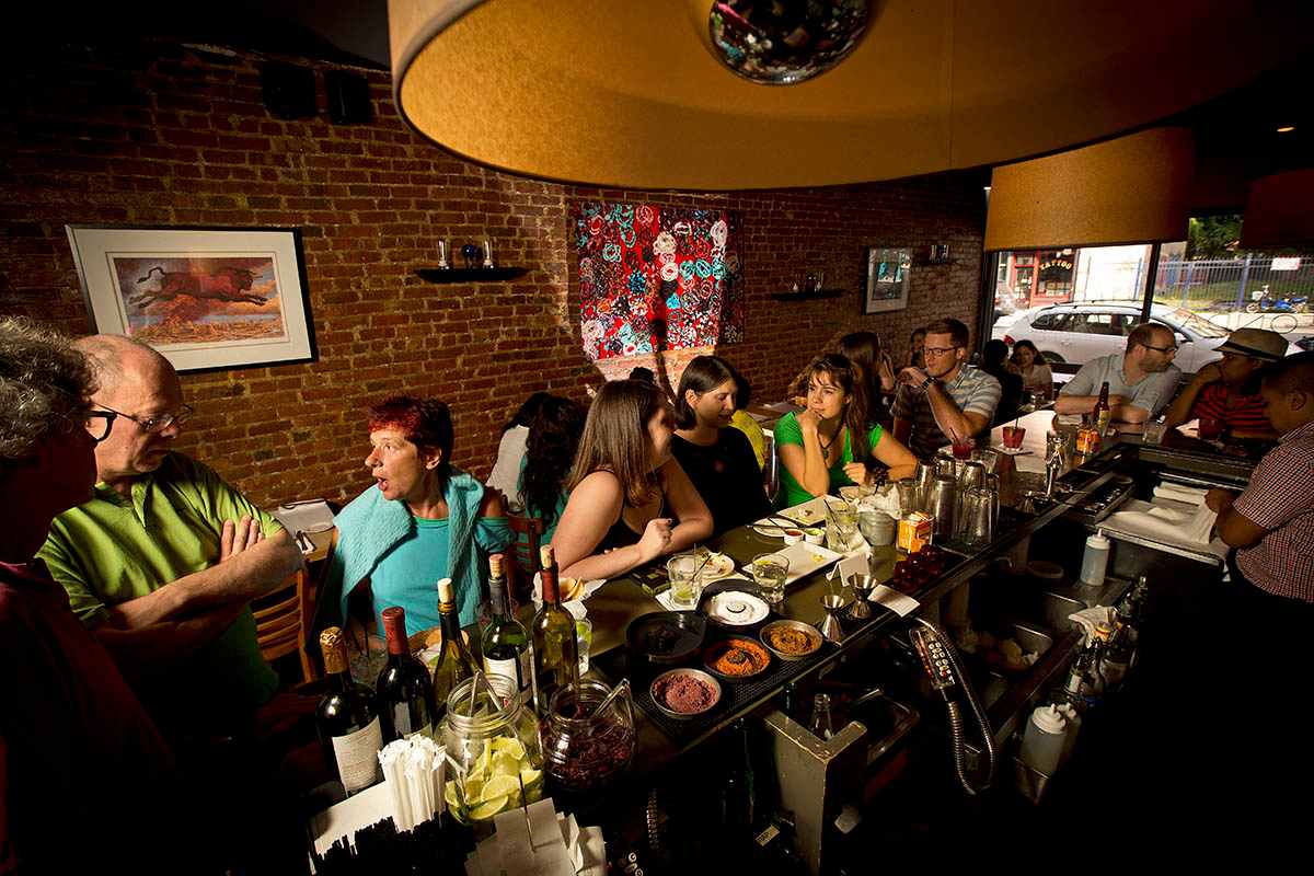 people-eating-and-drinking-at-bar-of-fonda-restaurant