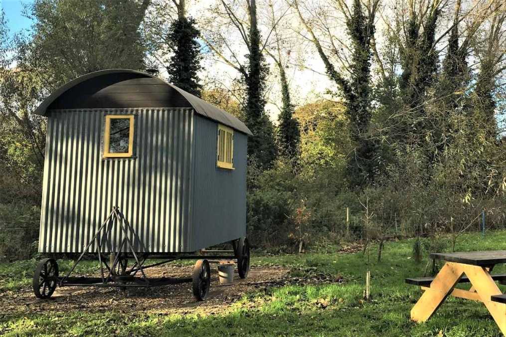 fen-lodge-shepherds-hut-in-field-with-picnic-table