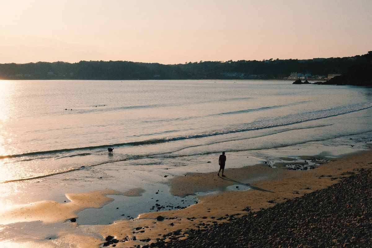 man-walking-down-beach-at-sunset-3-days-in-jersey-itinerary