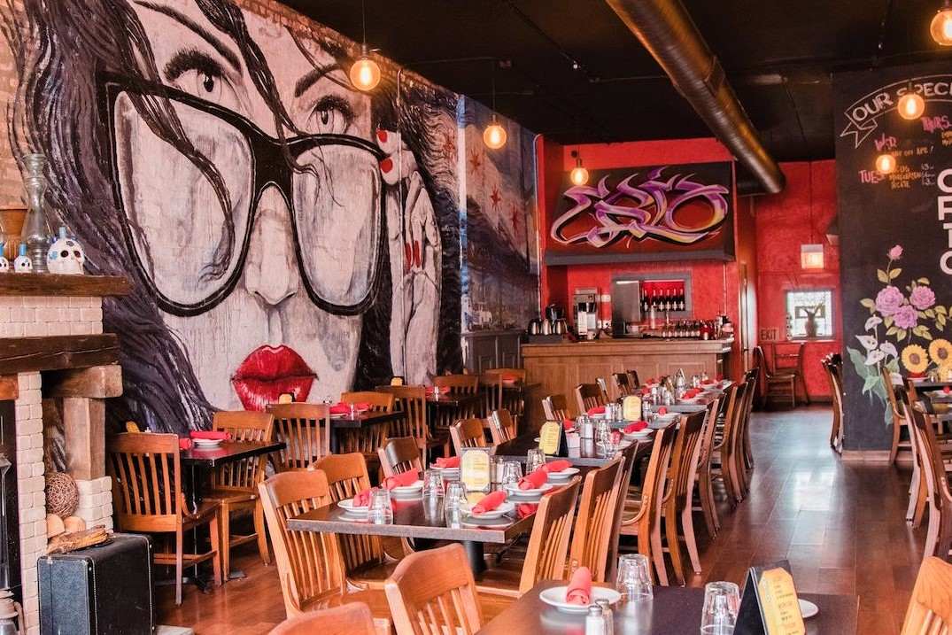 restaurant-tables-inside-crio-with-grafitti-on-wall
