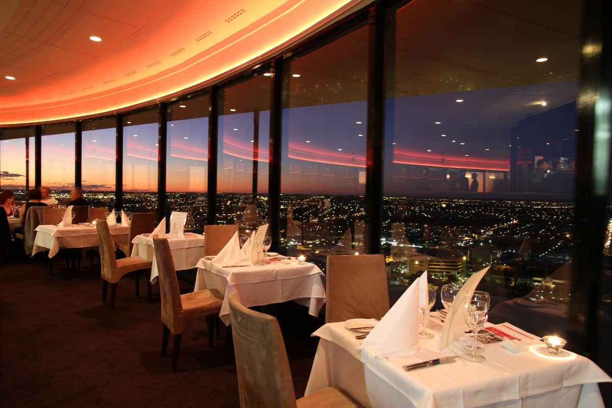 tables-in-c-restaurant-in-the-sky-overlooking-city-at-sunset