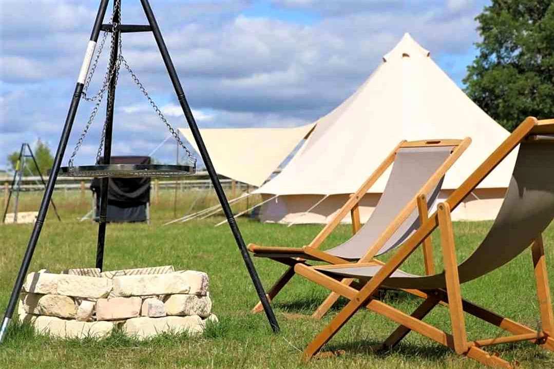 fire-pit-deck-chairs-and-bell-tent-in-field-at-lacock-alpaca