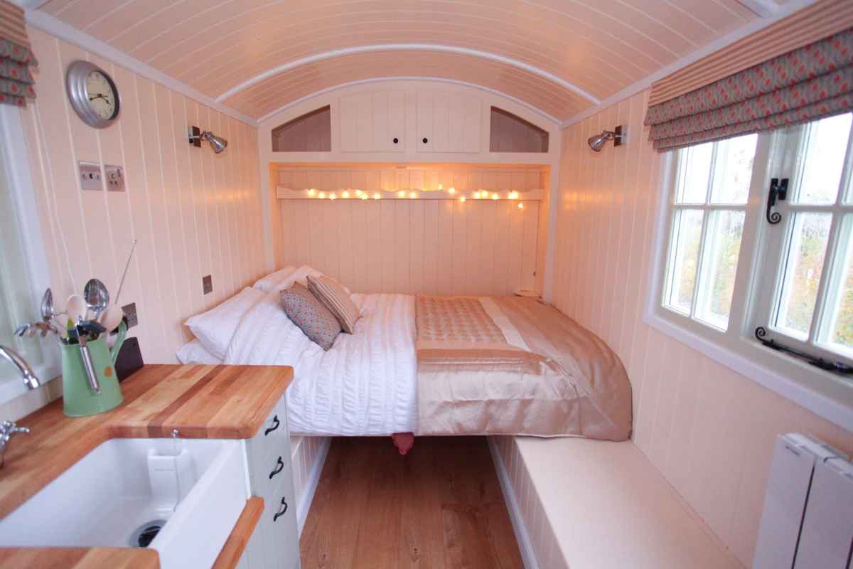 kitchen-and-double-bed-inside-abbey-farm-shepherds-hut