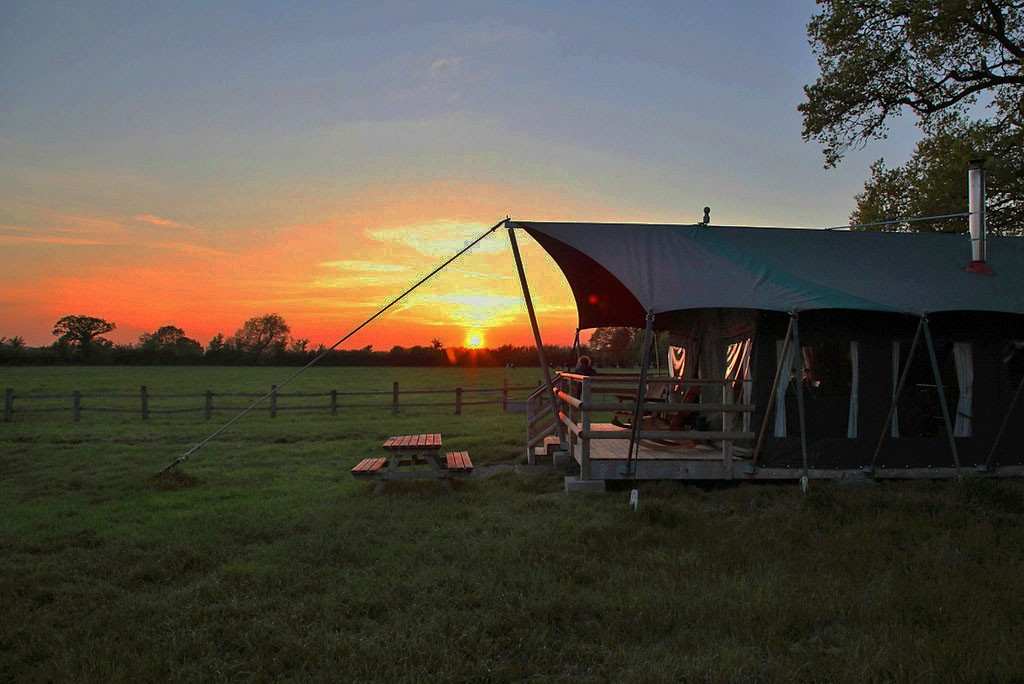 safari-tent-in-field-at-mill-farm-glamping-at-sunset