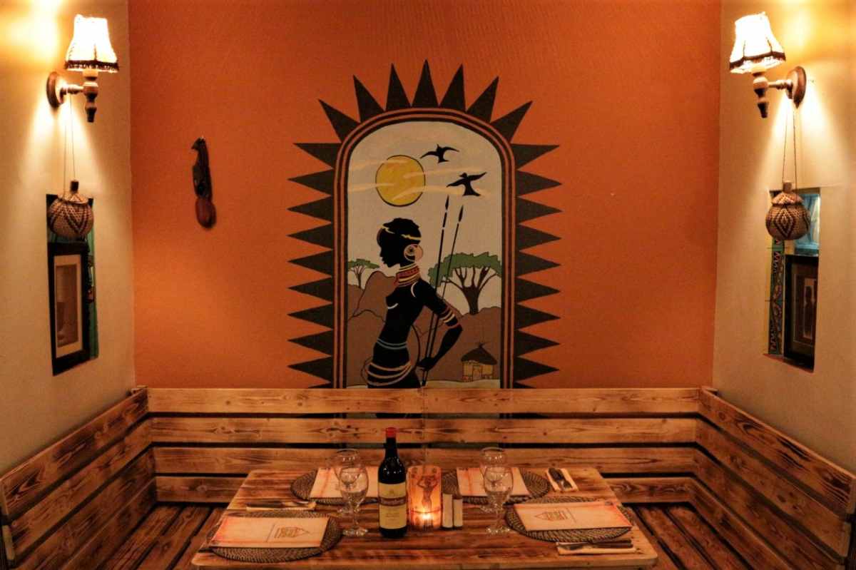table-against-orange-wall-in-braai-shack-restaurant