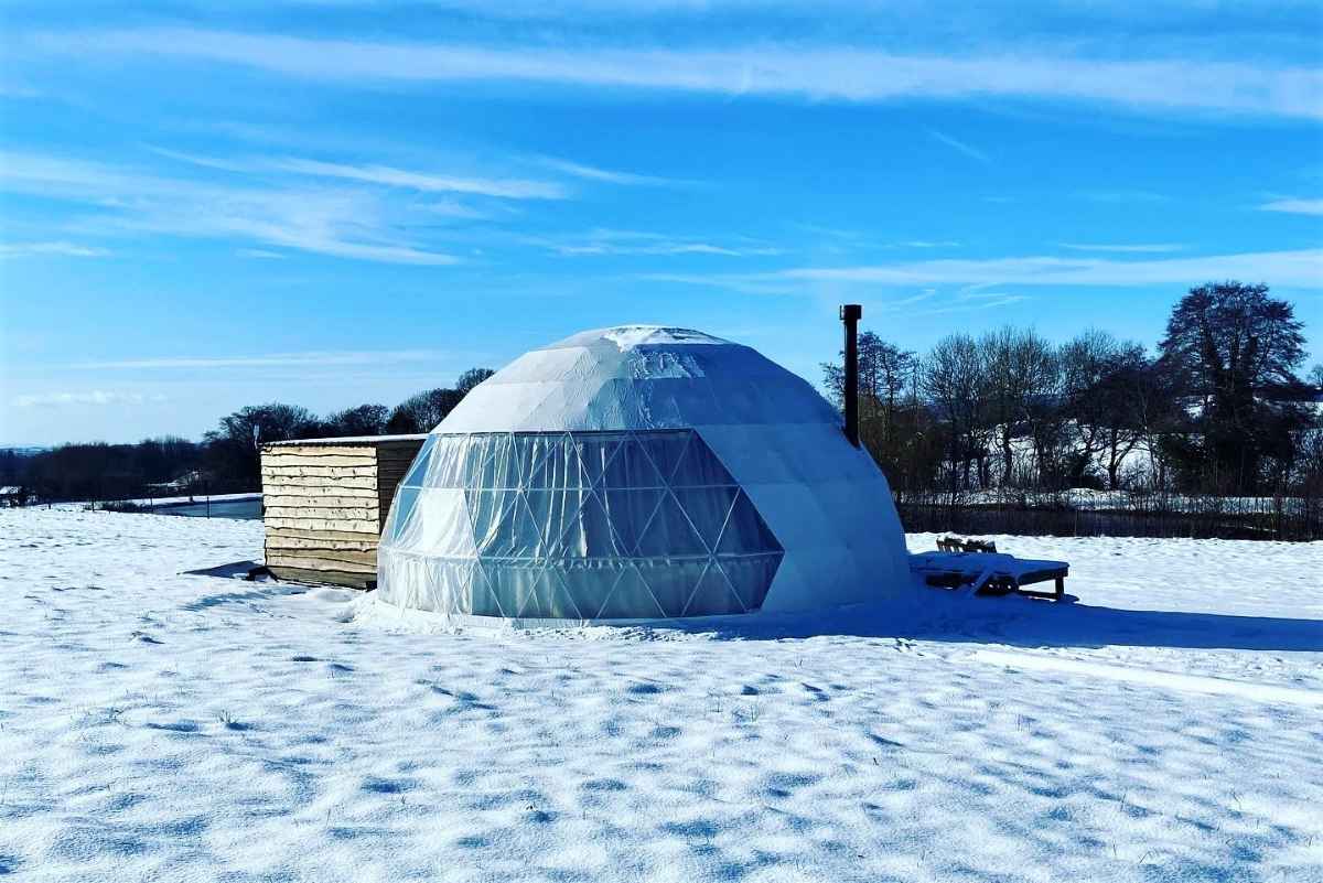 the-owlet-dome-in-snowy-field-on-sunny-day