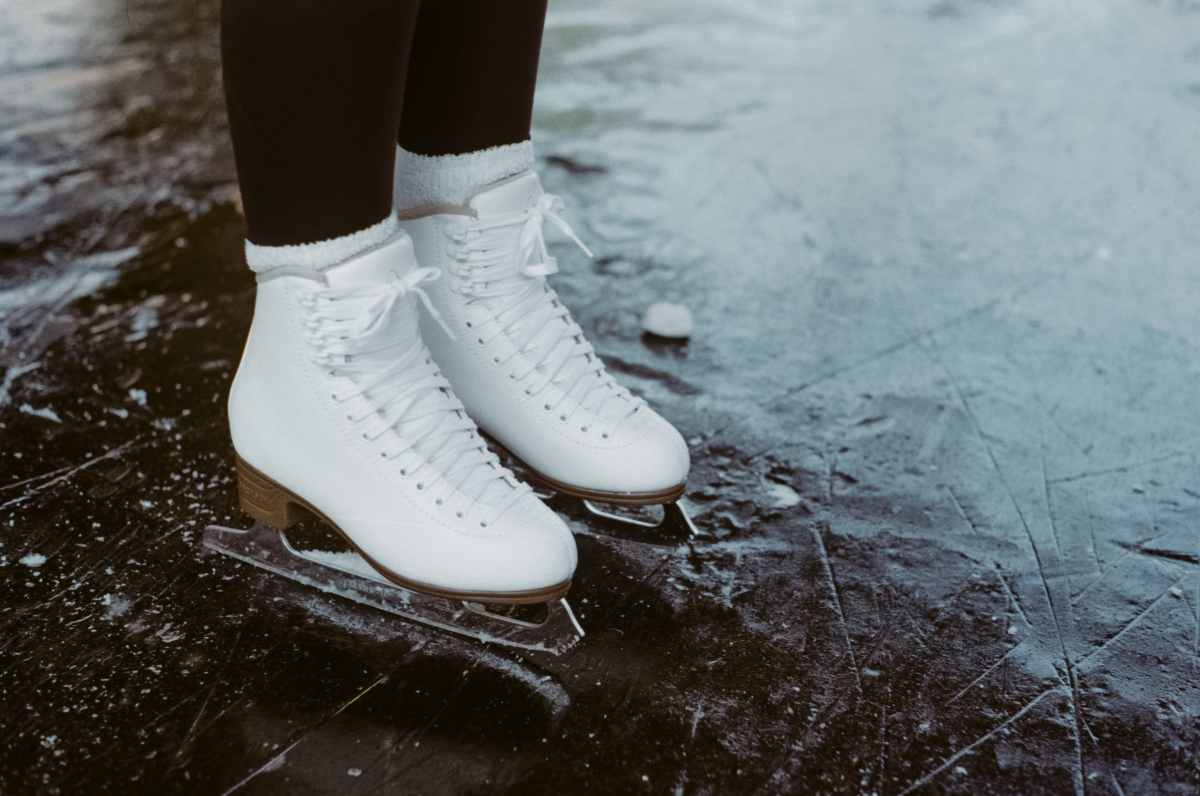 white-ice-skates-on-ice-rink-in-winter