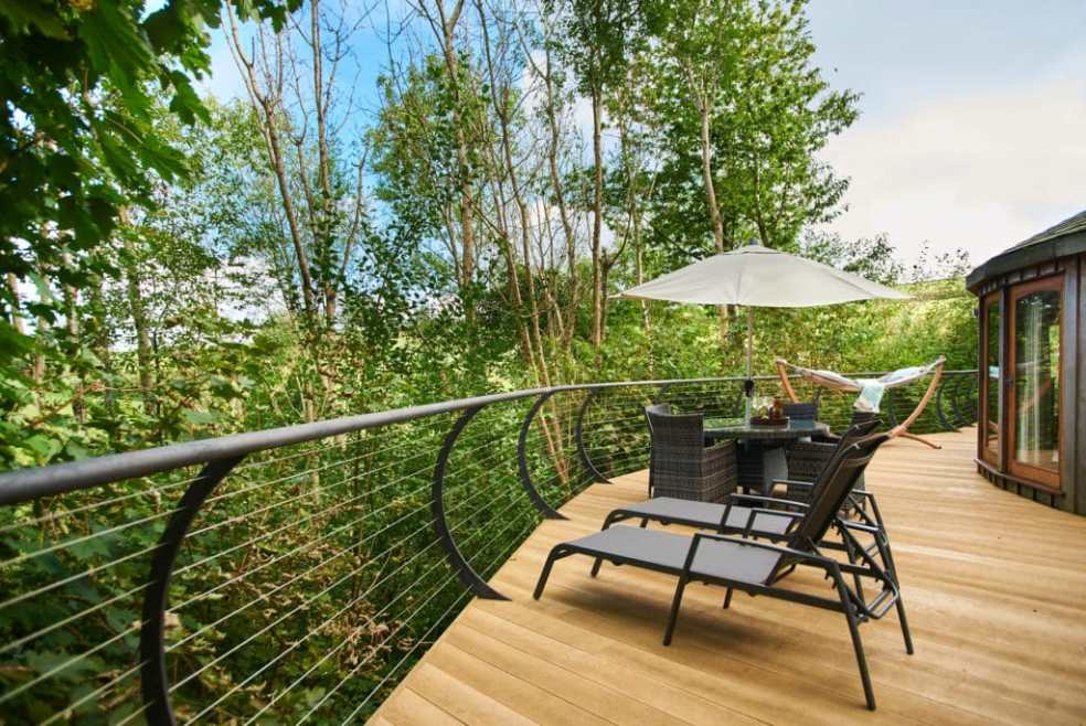 sun-loungers-and-table-on-decking-of-dittisham-hideaway-treehouse