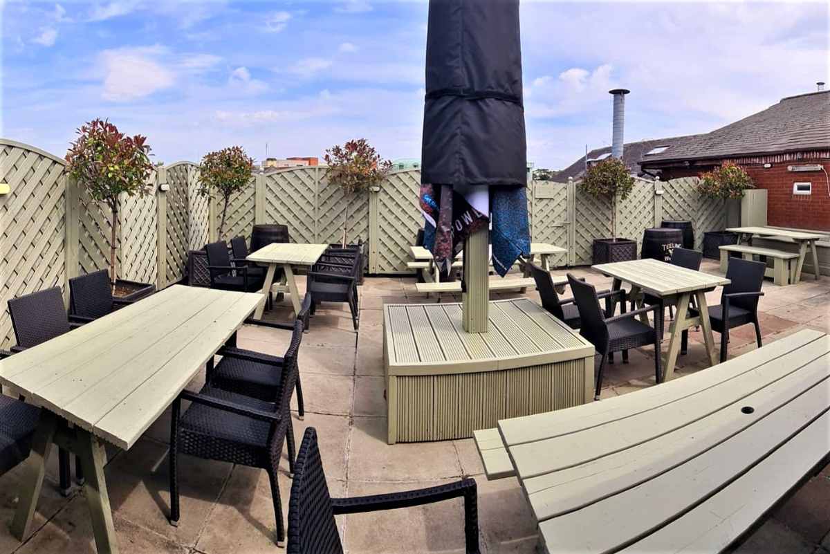 tables-on-terrace-of-gunpowder-bar-and-grill-in-daytime