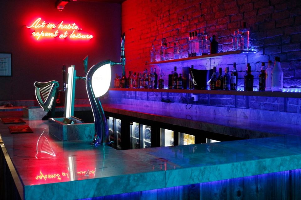 neon-sign-behind-bar-of-dusk-bar-bistro