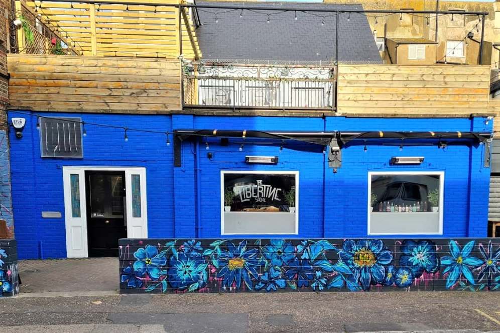 blue-exterior-of-the-libertine-social-bar-in-daytime