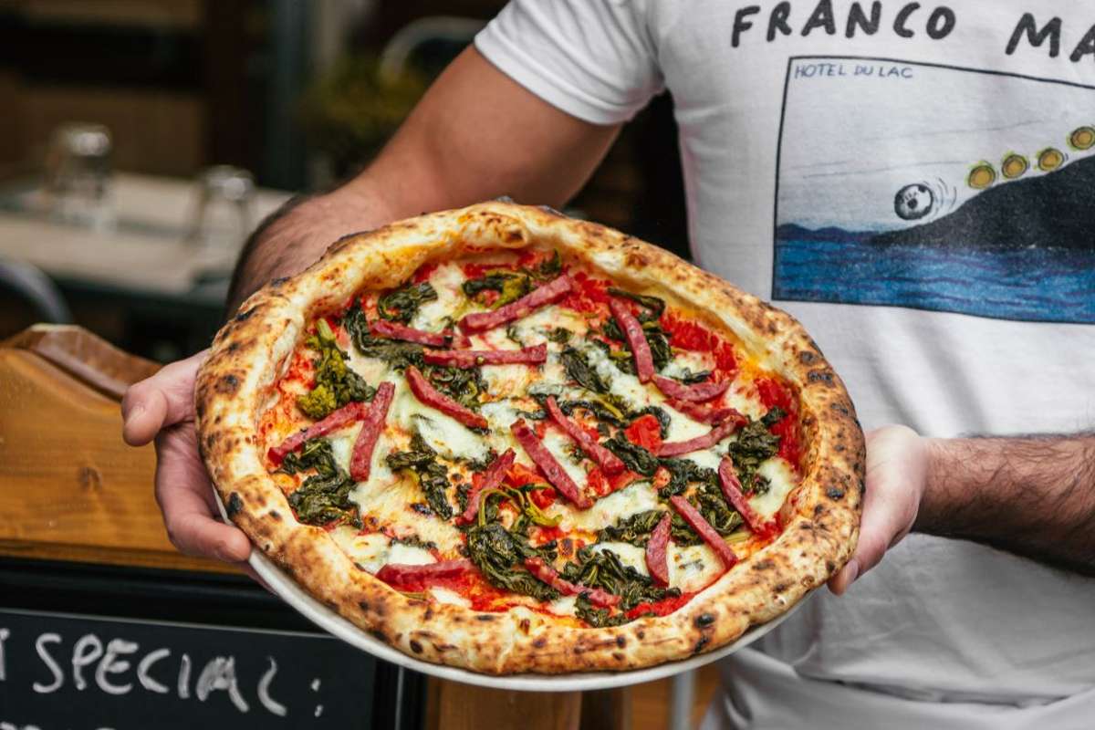 franco-manca-vegetable-pizza-in-a-mans-hands