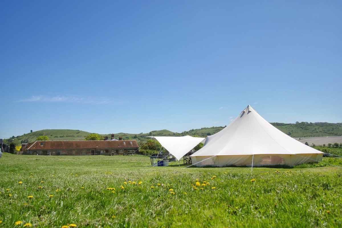 town-farm-camping-bell-tent-in-field-in-daytime