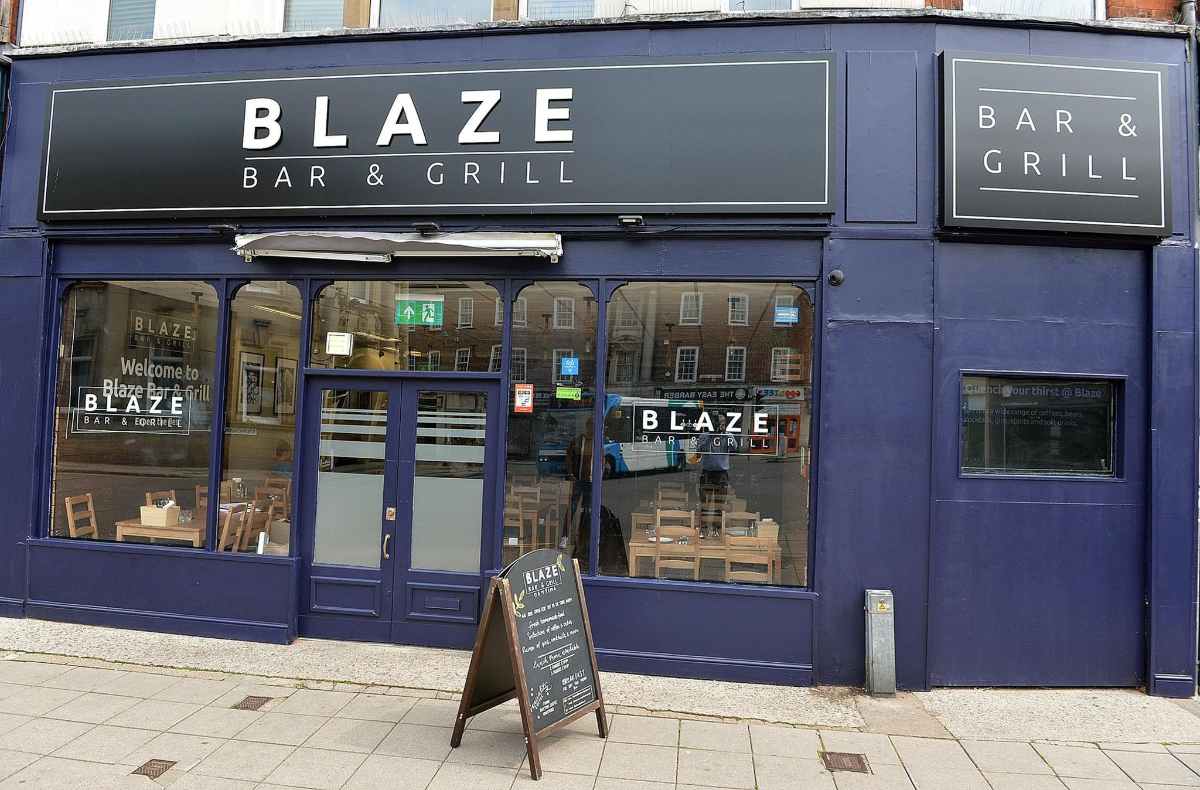 blue-exterior-of-blaze-bar-and-grill-in-daytime