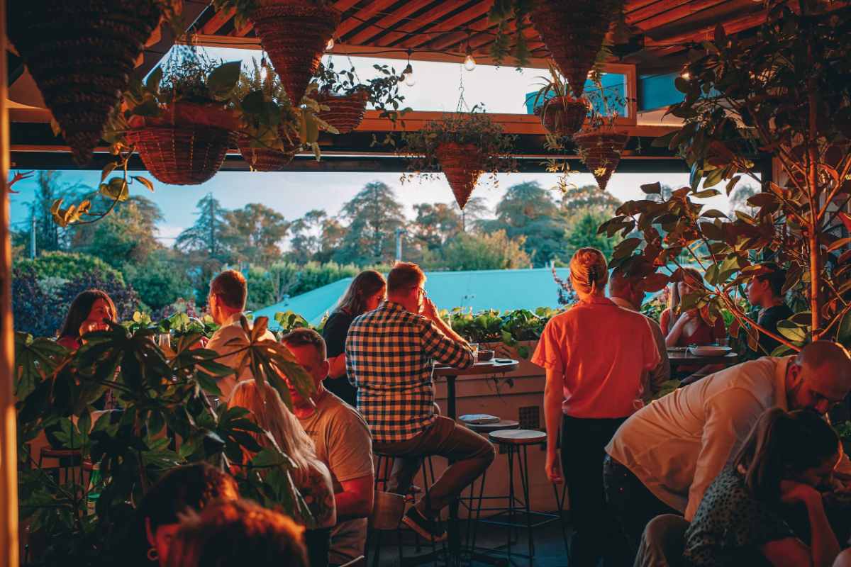 people-drinking-on-terrace-of-edgar's-inn-at-sunset
