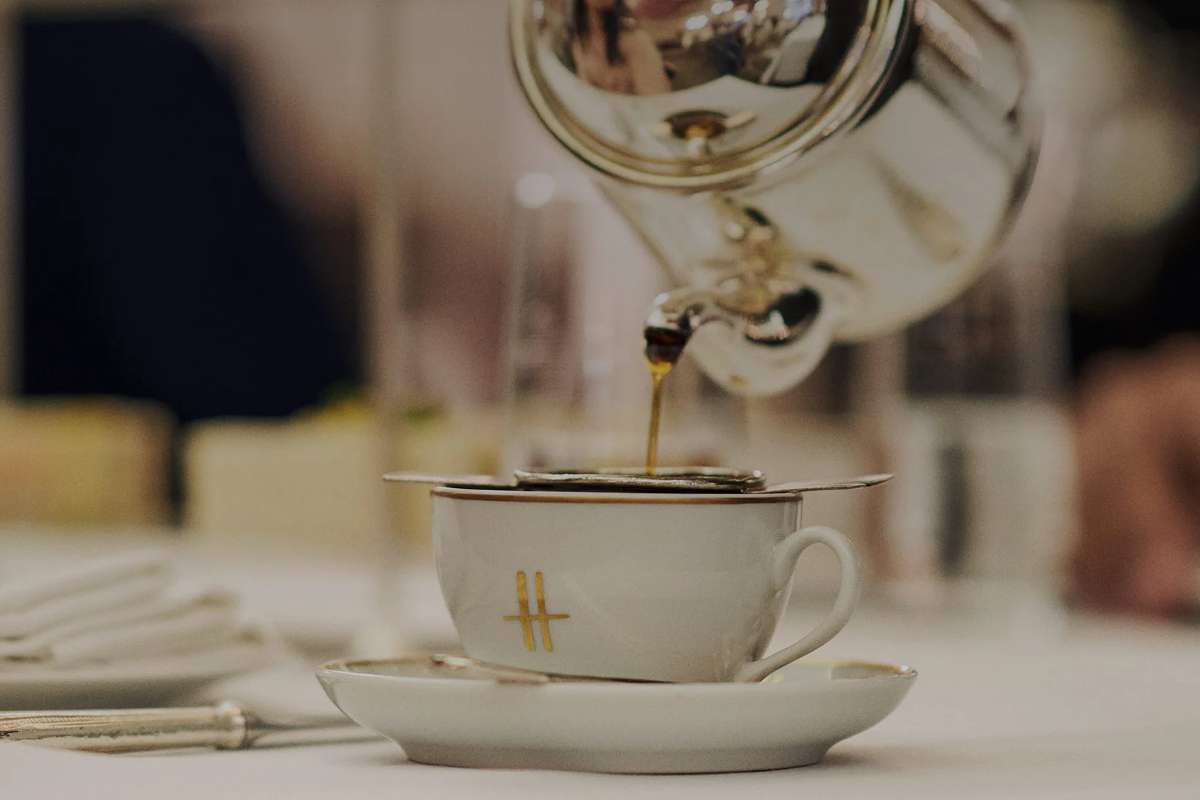 tea-being-poured-into-a-teacup-at-harrods-tea-room