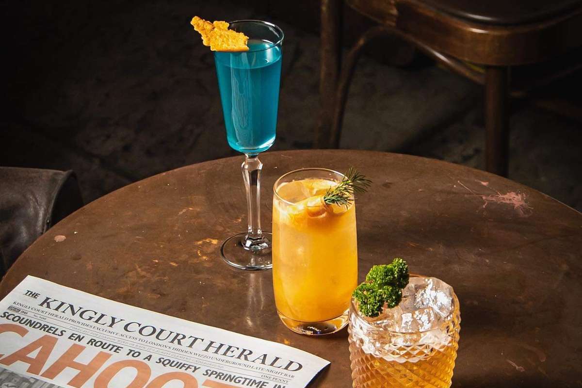 cocktails-and-a-newspaper-on-the-table-at-cahoots