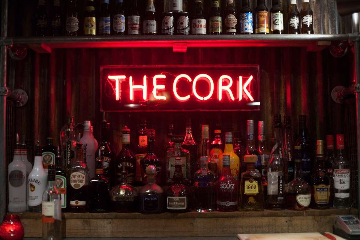 bar-shelves-and-neon-sign-at-the-cork