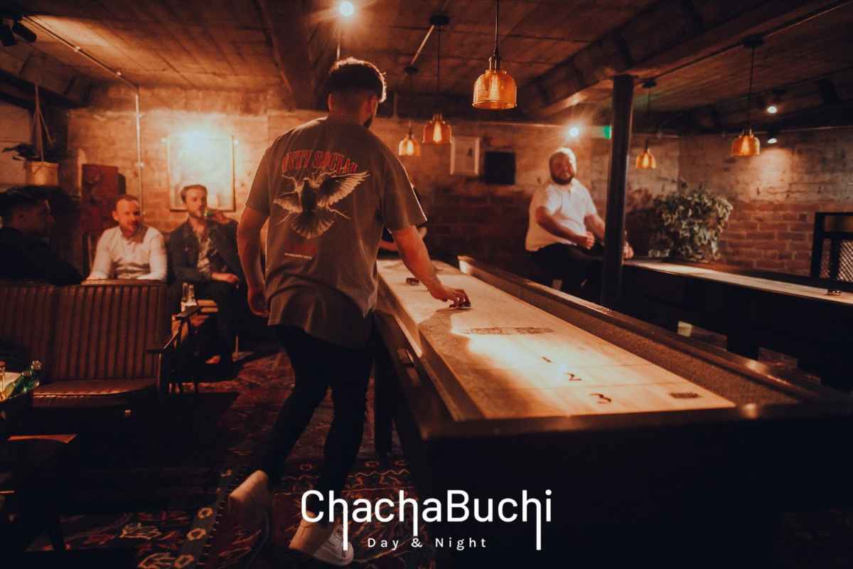 guys-playing-shuffleboard-at-chachabuchi-cocktail-bar