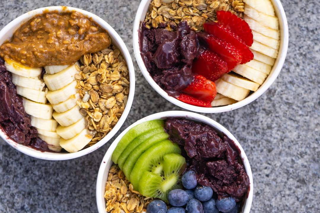 three-acai-bowls-topped-with-fruit-from-mojo-health-bar