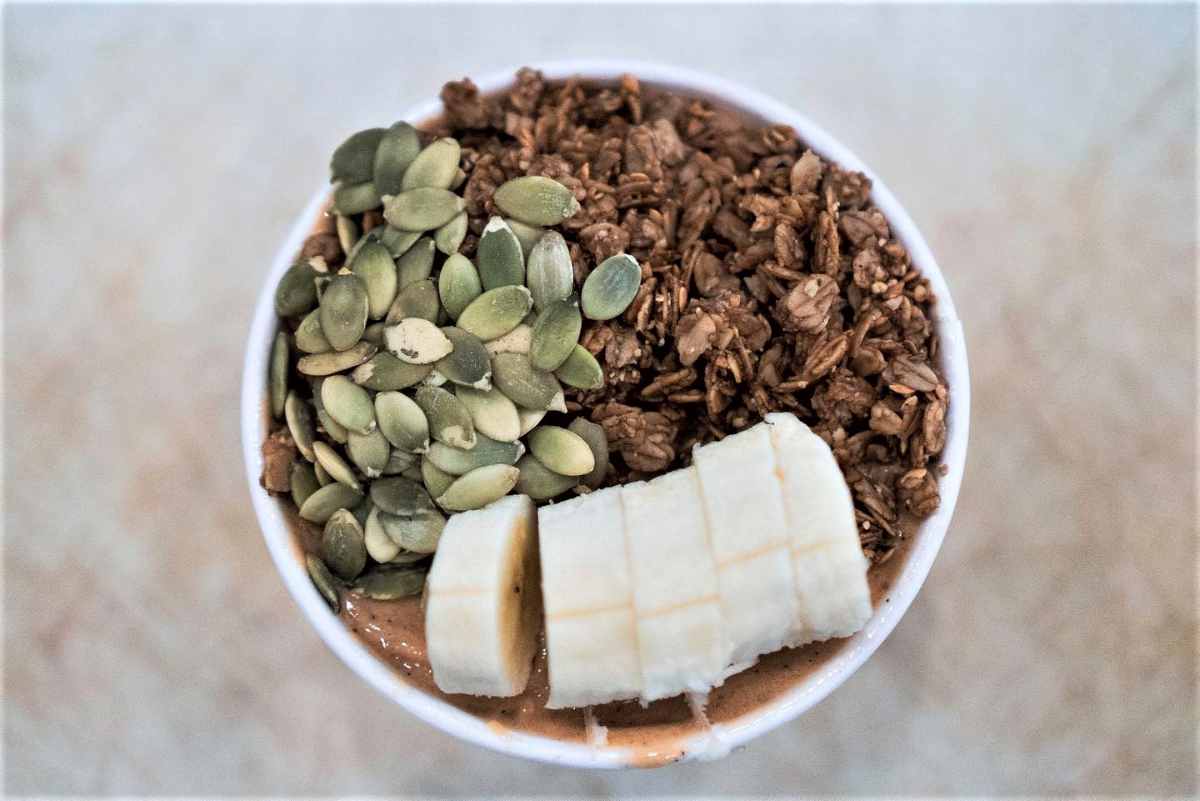 acai-bowl-with-banana-granola-and-pumpkin-seeds-at-clean-juice