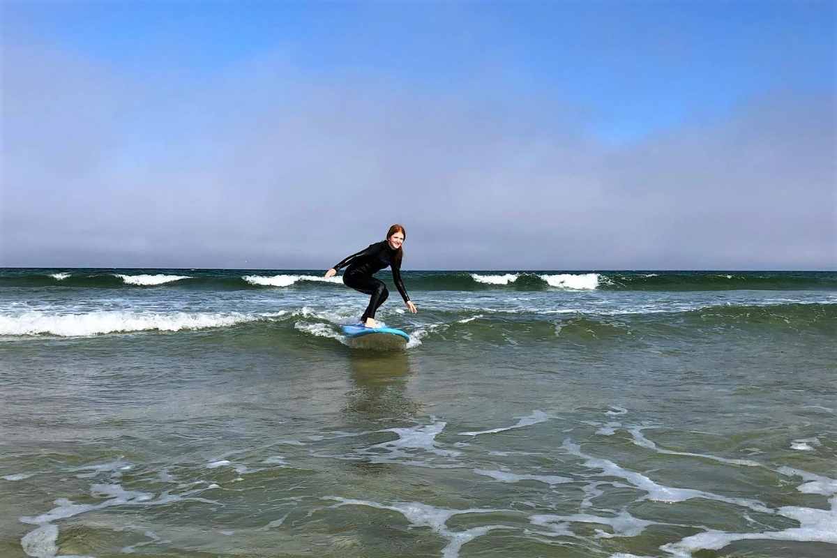 ginger-girl-surfing-at-surf-lewis-on-sunny-day