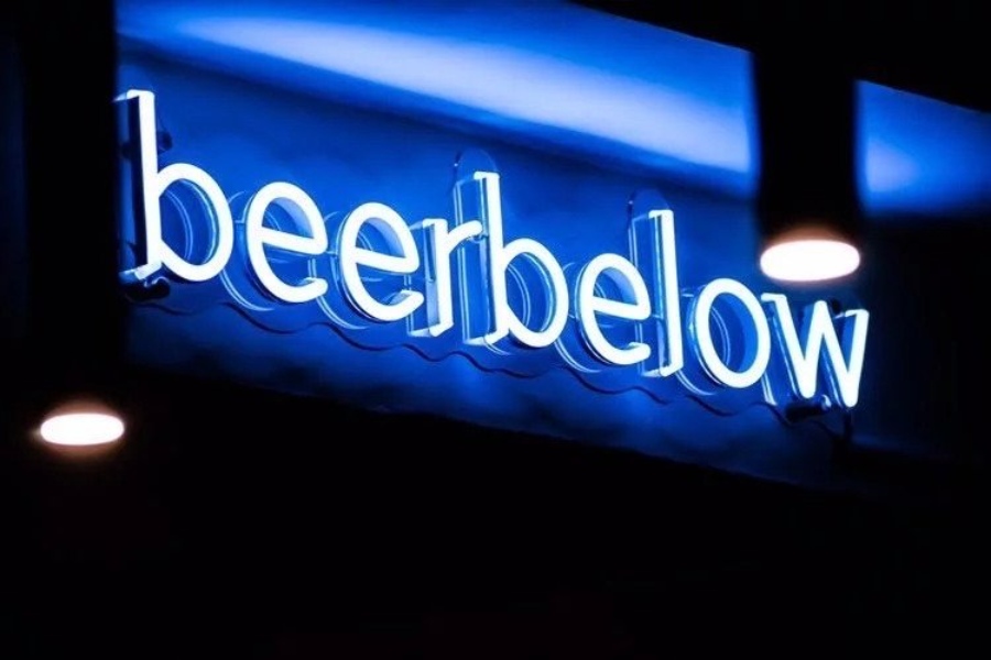 neon-blue-beerbelow-sign-at-barbelow-bar