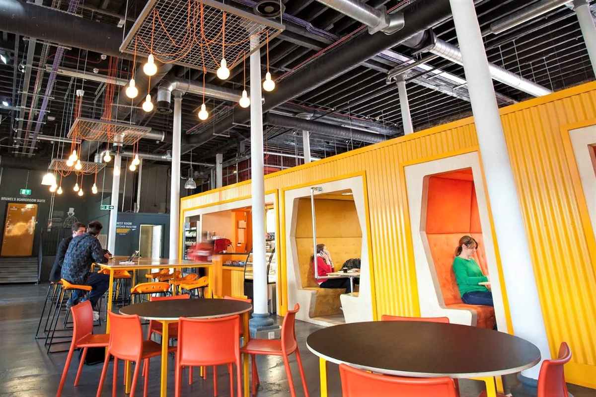 yellow-and-orange-booths-and-tables-inside-engine-shed