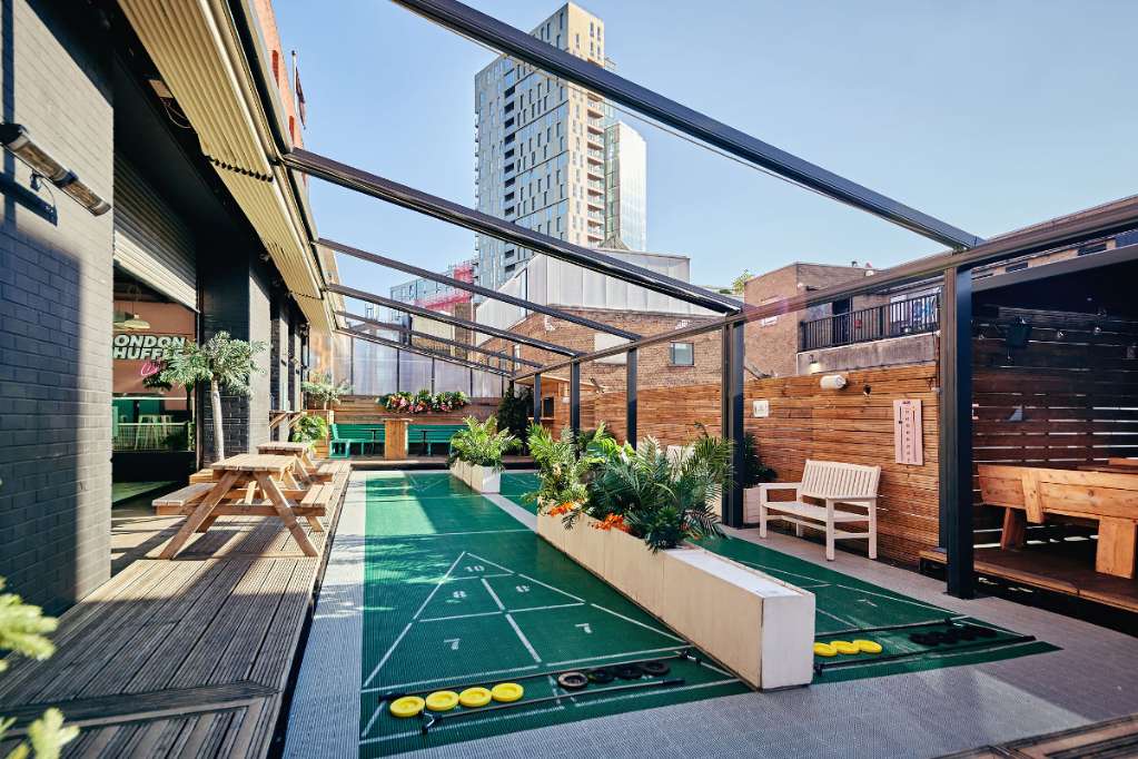 exterior-terrace-with-shuffleboard-at-london-shuffle-club-in-the-daytime