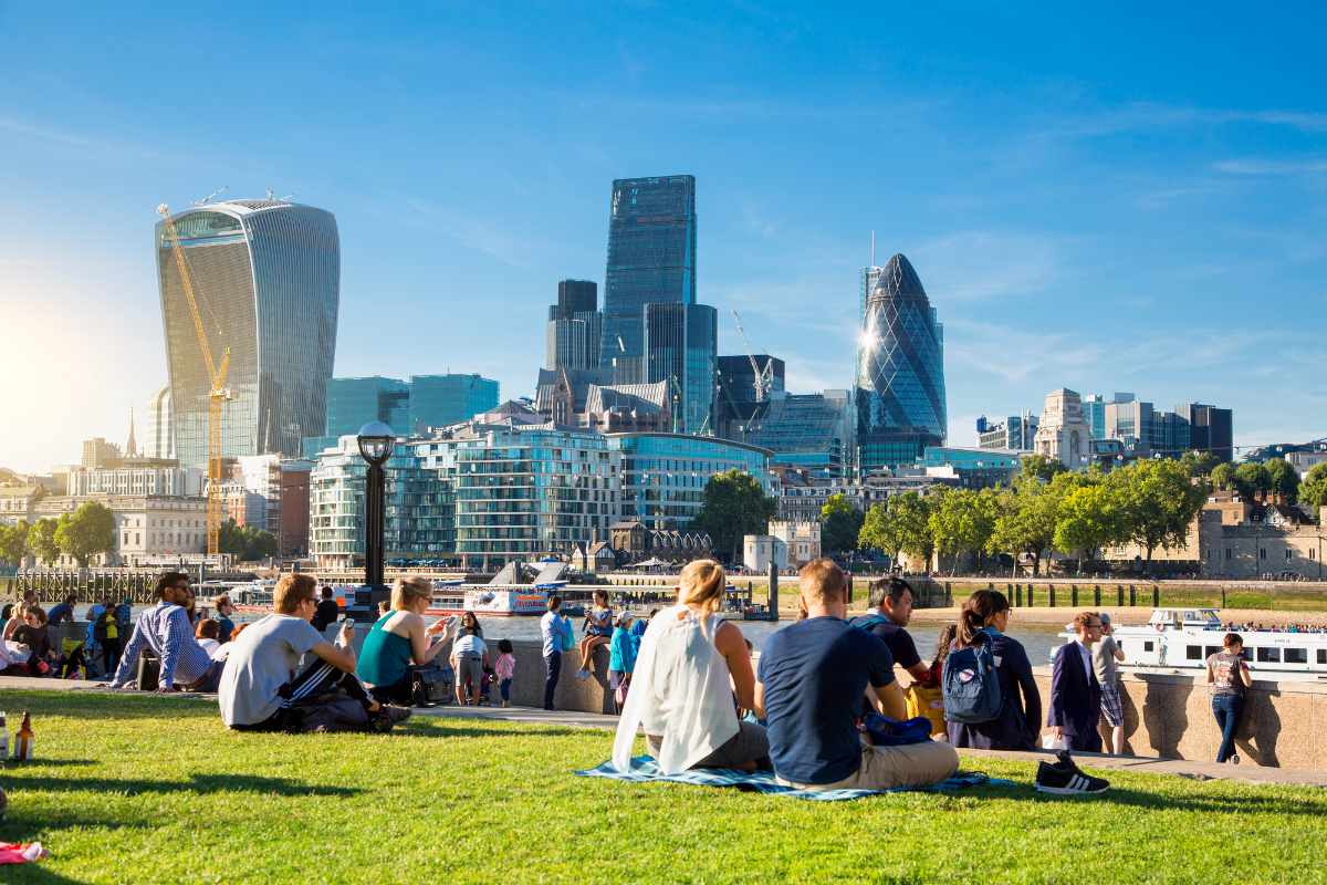crowds-on-grass-by-the-river-thames-on-sunny-day