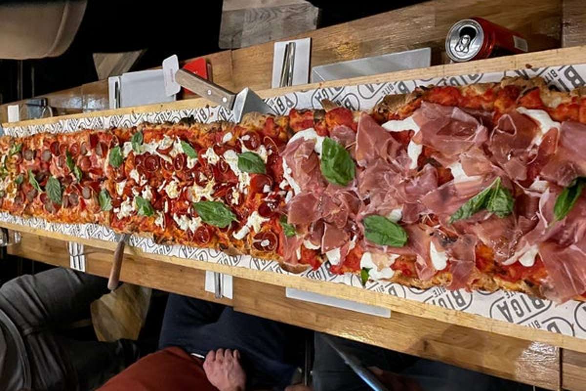 long-pizza-on-the-table-at-biga-bite