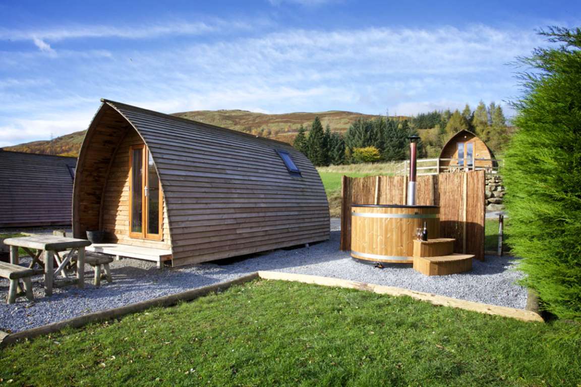 exterior-of-pod-with-hot-tub-at-loch-tay-highland-lodges-in-the-daytime