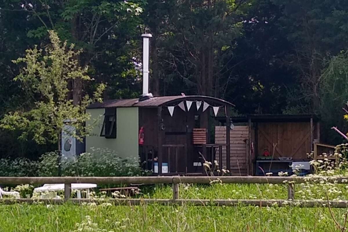 exterior-of-shepherd's-hut-at-twitey's-glamping-meadows-in-the-daytime