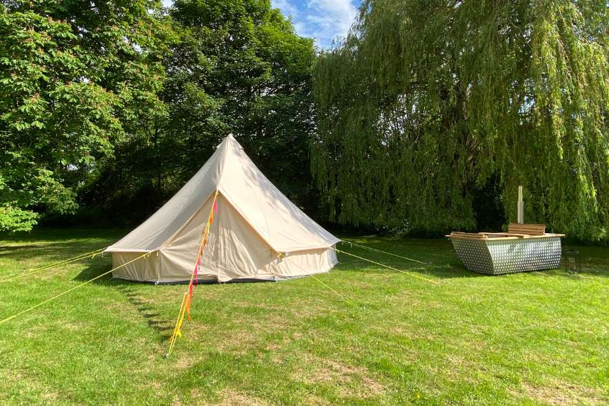 exterior-of-vip-tent-with-tub-at-the-cambridge-glamping-co-in-the-daytime