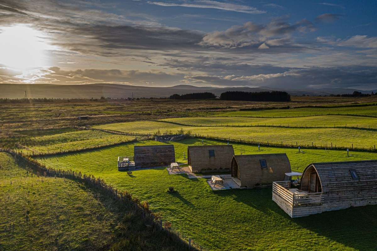 view-of-pods-in-a-field-at-loch-shin-glamping-pods-in-the-daytime