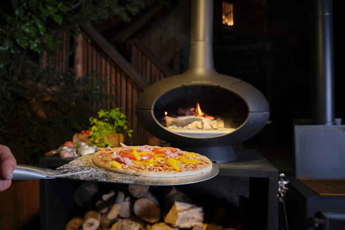 pizza-coming-out-of-wood-fired-pizza-oven
